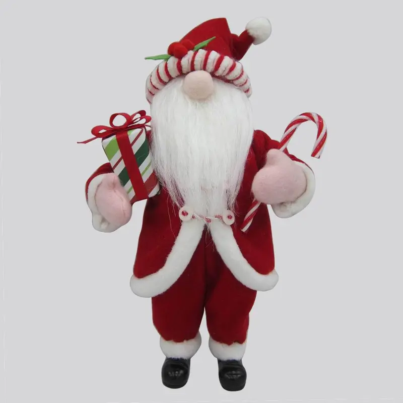 Santa gnome in cotton jacket holding presents and candy cane