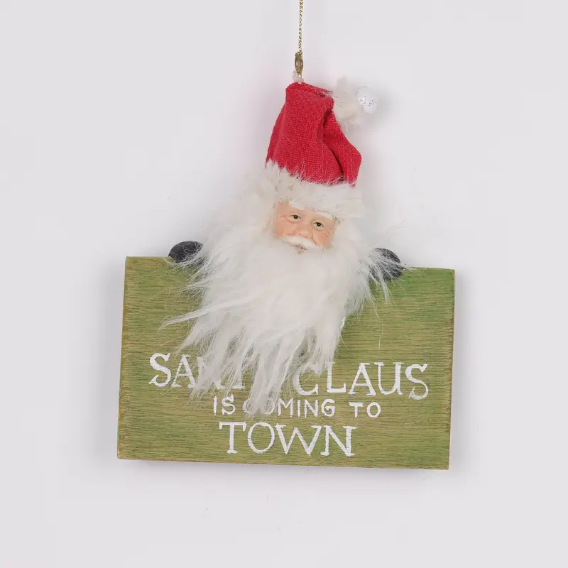 Santa Claus holding a signage ornament