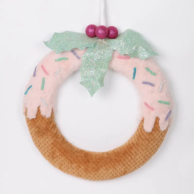 Brown donut with pink frosting wreath with blue mistletoe