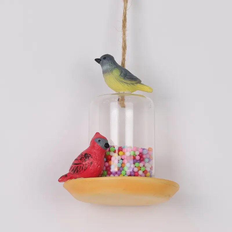 Polyresin birds on plastic bird feeder ornament